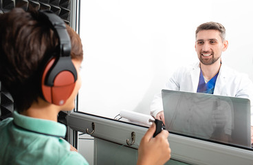 audiologist doing hearing test to a child. audiometry test. © Peakstock