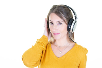 Gorgeous blonde woman listening music in headphones singing on white background