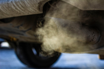 smoke from the exhaust pipe of the car in the winter cold season