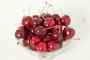 Fresh cherry glass bowl ready to serve. White background and perfect for adding text
