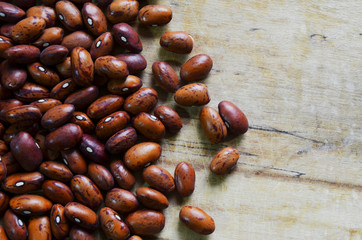 Brown dried bean grains on old wood