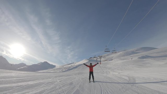 Man skiing on snowy slope at ski resort in the mountains