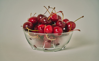 Fresh cherry glass bowl ready to serve. White background and perfect for adding text