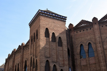 Fototapeta na wymiar Square Tower & Ornate Features on Bare Brick Building 