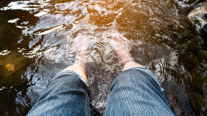 Foot tourists soaking in the hot springs at Sankampang, Chiang Mai, Thailand