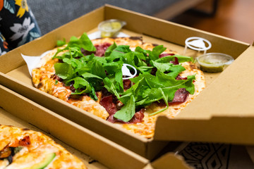 Take Away Pizza Box with Arugula, Rocket or Rucola Leaves and Avocado.