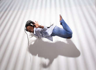 trendy concept, african american woman levitating over light abstract stripy background with a...