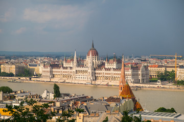 View of historical building of Hungarian Parliament on Danube river in Budapest, Hungary, Europe.