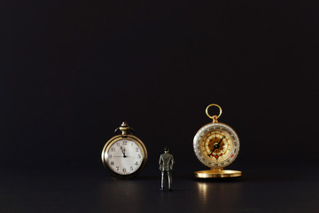 leadership concept, businessman looking at compass and alarm clock inspiration and vision idea