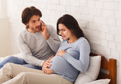 Worried Husband Calling Doctor For His Pregnant Wife Having Contractions