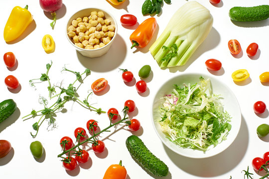 Healthy Salad Ingredients On White Background In Hard Sun Light With Harsh Shadows. Vegan Meal. Pattern Isolated