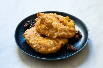 Fried Pineapple Fritters Caramelized with Cinnamon and Sesame Seeds.