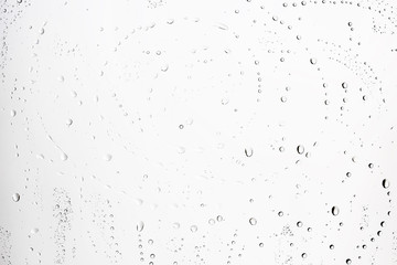 white isolated background water drops on the glass / wet window glass with splashes and drops of water and lime, texture autumn background