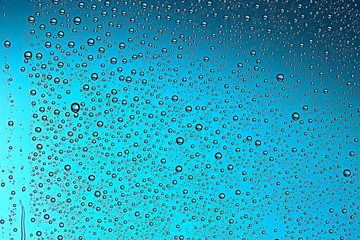 fresh drops background blue glass / wet rainy background, water drops transparent glass blue