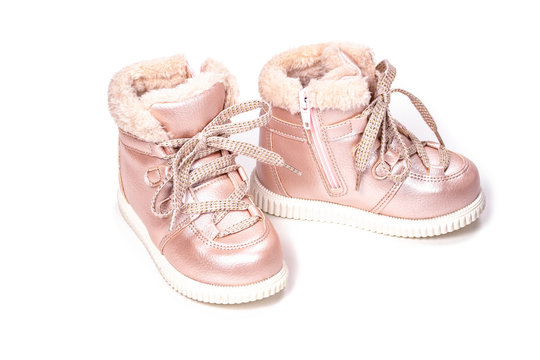 Children shoes, pink boots with faux fur for the winter on a white background. Lacing eco-friendly children's winter shoes