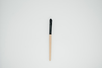 Makeup brush on light background close up