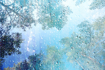 summer rain wet glass / abstract background landscape on a rainy day outside the window blurred background