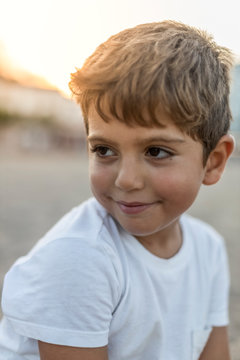 Portrait of a cute little boy at sunset