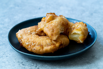 Fried Pineapple Fritters Caramelized with Cinnamon and Sesame Seeds.