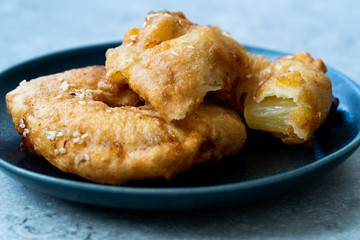 Fried Pineapple Fritters Caramelized with Cinnamon and Sesame Seeds.