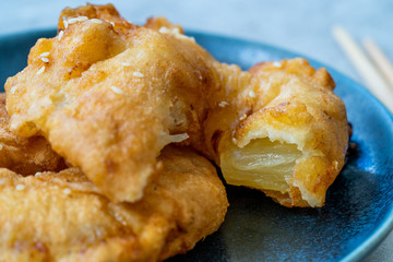 Fried Pineapple Fritters Caramelized with Cinnamon and Sesame Seeds.