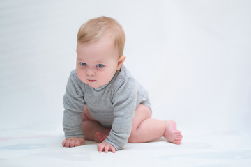 a six-month-old baby learns to crawl. emotional portrait of a child