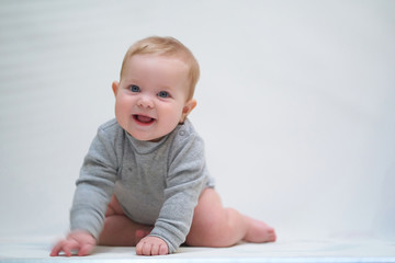 a six-month-old baby learns to crawl. emotional portrait of a child