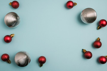 Christmas winter composition. Red and silver balls on blue background. Top view, flat lay