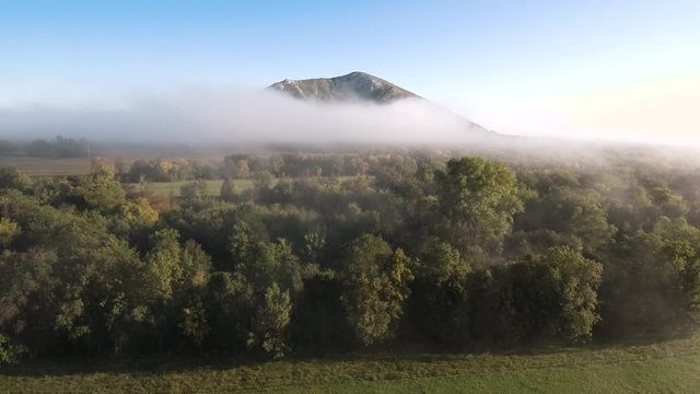 The remain of the reef of the ancient sea, composed of limestone - shikhan Yuraktau. Indian summer in the floodplain of the Belaya River. Aerial view.
