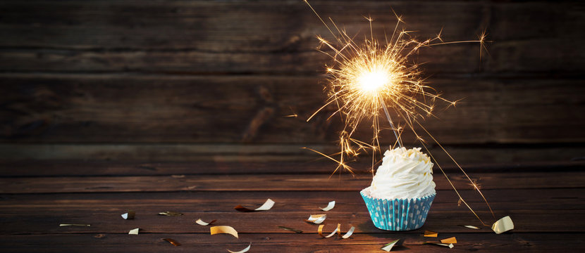 Birthday Cake With Sparkler On Old Wooden Background