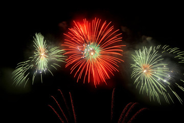 Colorful fireworks that explode and fill the darkness of the night sky with colored light.