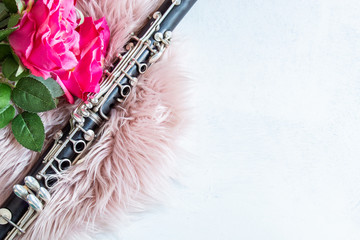 Musical and romantic background with clarinet as a musical instrument and roses