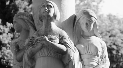 Black and white  image of antique statue of three women as a symbol of time: past, present and...