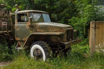 Lutsk, Ukraine - August 11, 2019:  Old and abandoned Soviet military truck on background of autumn trees