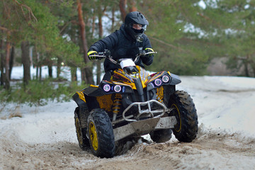 Fototapeta na wymiar ATV and UTV driving in mud and snow at winter. ATV/UTV/4x4 off-road