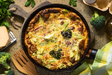 Frittata with sausage and vegetables in skillet.