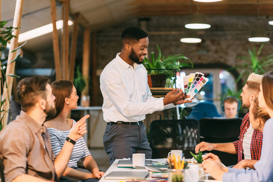 Young team choosing colors for new project, discussing work