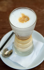 top view on latte coffee in a figured glass