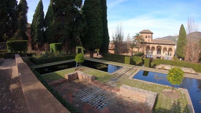 Panning view the gardens of the Partal in Alhambra Place. Granada, Andalusia, Spain. Pamoramic shot, 4K.