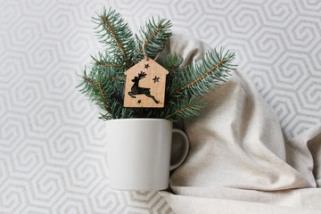 beautiful cup on a light background with a Christmas branch