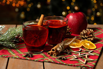 Glasses of mulled wine. Cinnamon, a branch of spruce and Christmas cookies on the New Year