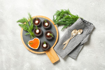 Red caviar in black tartlets