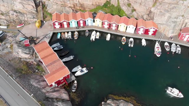 Smooth drone aerial flight from right to left with view of small marina with yachts at Smogen, Bohuslan in Sweden