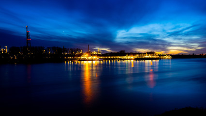 Fototapeta premium River rhine with oil refinery in the background, longtime shot near Cologne, Germany