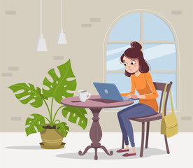 Woman is sitting in a cafe with a laptop and a cup of tea or coffee.