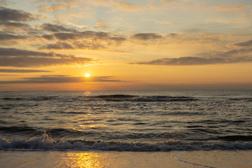 Beautiful view of Black Sea with first rays of rising sun. Magical beauty of dawn. Colorful sky with clouds and gold. Beautiful composition of nature for natural background any design