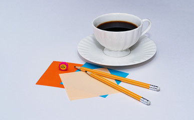 invigorating coffee on a white background with tangerines, pencils and Christmas tree toy