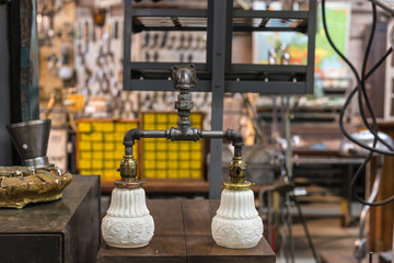 Bath light fixture made from industrial metal pipes with vintage ceramic light covers
