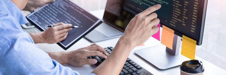 Pensive programmer working on on desktop pc programming code technologies or website design at...