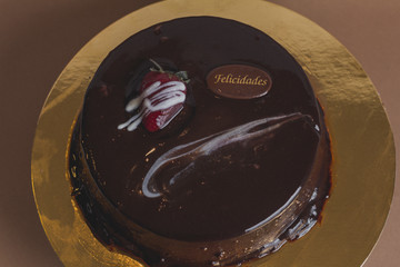 Sweet chocolate cake on gold table